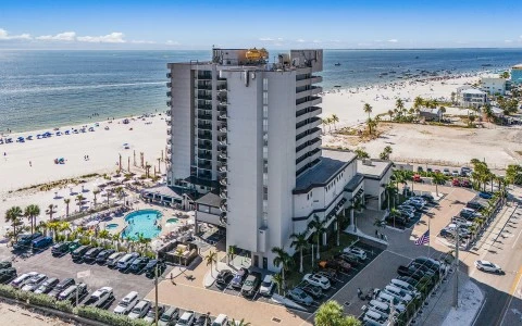 a building with cars parked on the beach