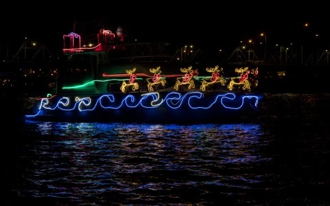 boat adorned with holiday lights