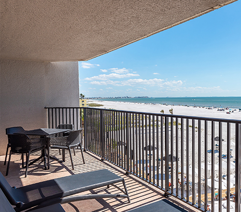 Woman in hat in sunglasses riding a cruiser bike along the beach