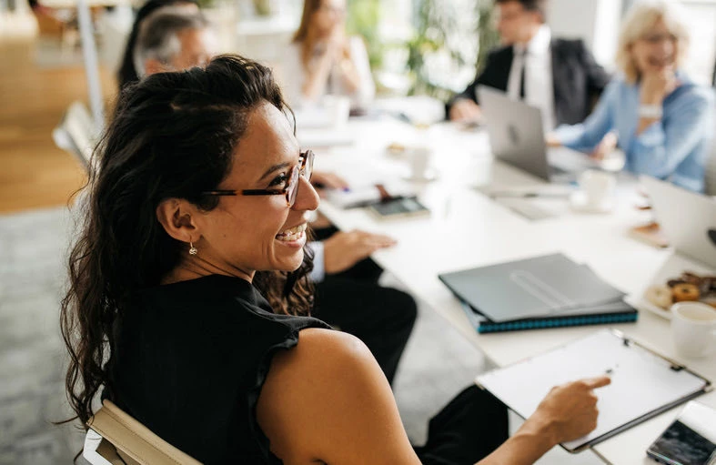 woman smiling at a meeting