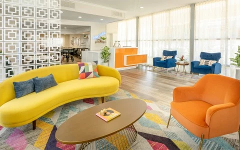 a room with a couch and chairs