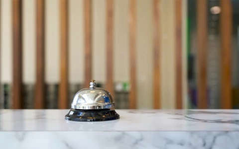 a close-up of check-in desk and bell