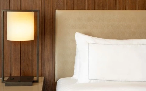 a bed with a white pillow