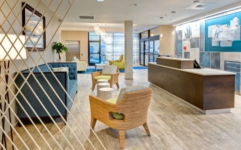 hotel lobby with check-in desk, sofa and chairs