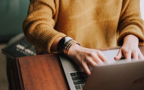 a person typing on a laptop