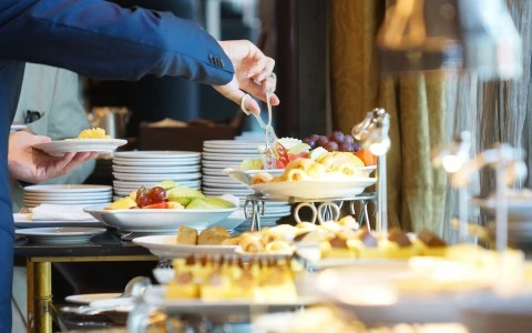 a person putting food on a table