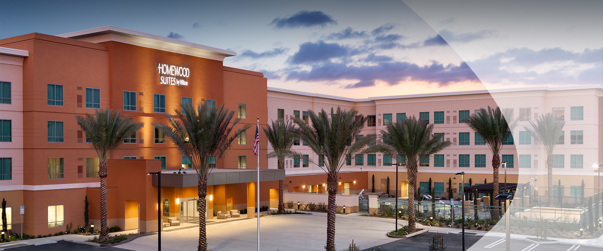 a building with palm trees and a flag