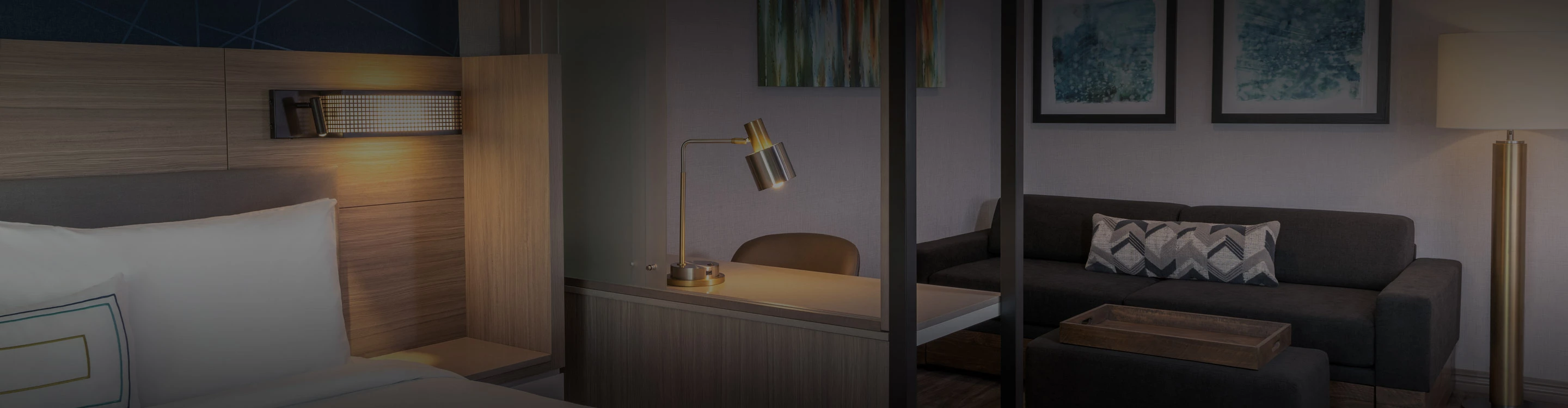 a desk with a lamp and chair