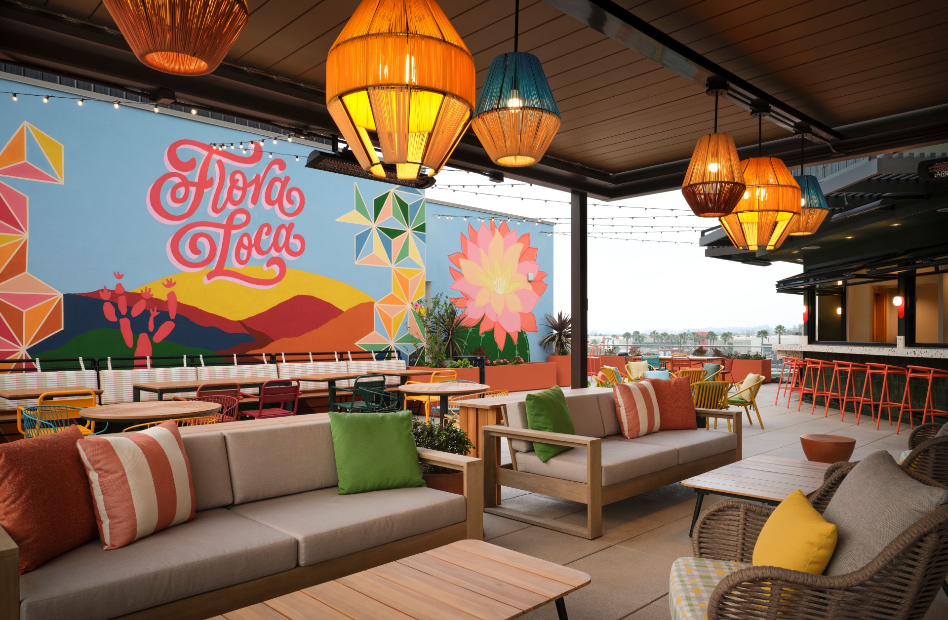a patio with couches and tables and lamps