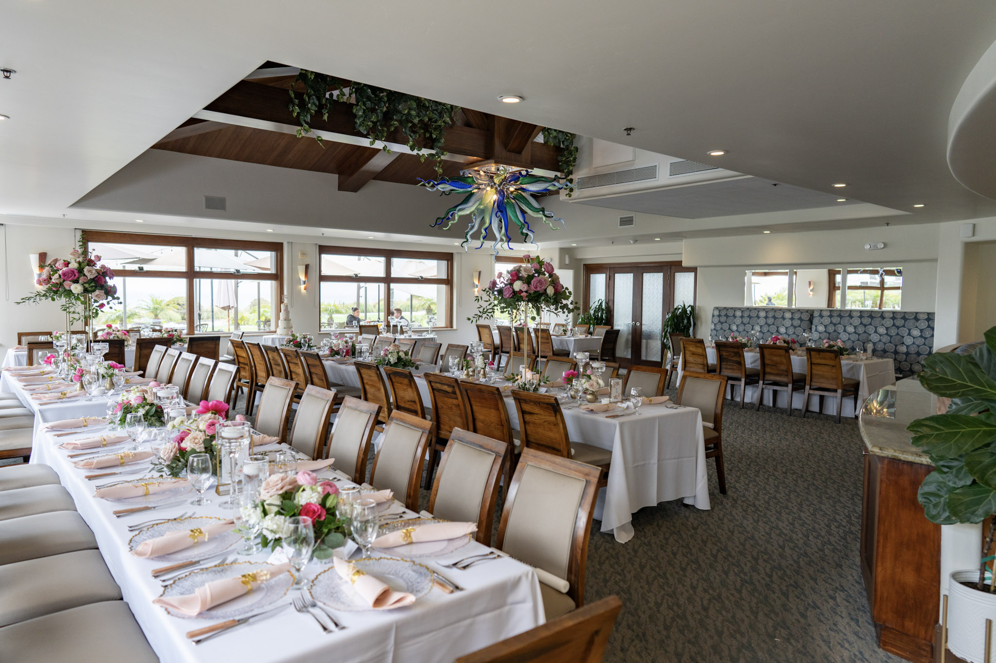 Spacious rustic-coastal dining room at Lido Restaurant & Lounge, Dolphin Bay Resort & Spa in Pismo Beach — warm wood tones, natural light, ocean views, and versatile table layouts for weddings, receptions, and private events.