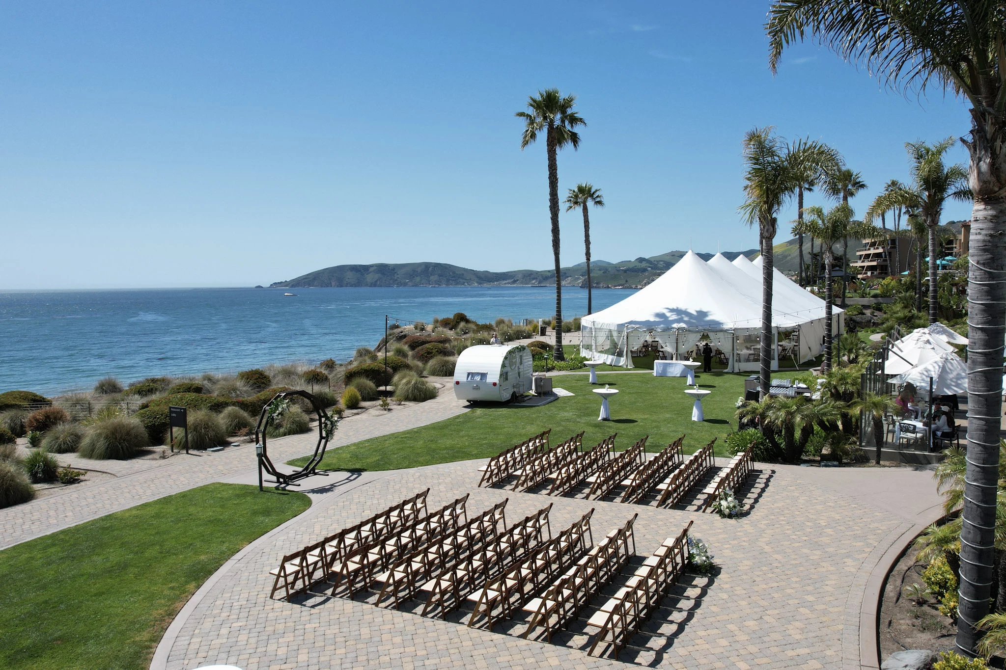 a group of chairs in a row next to a large white tent