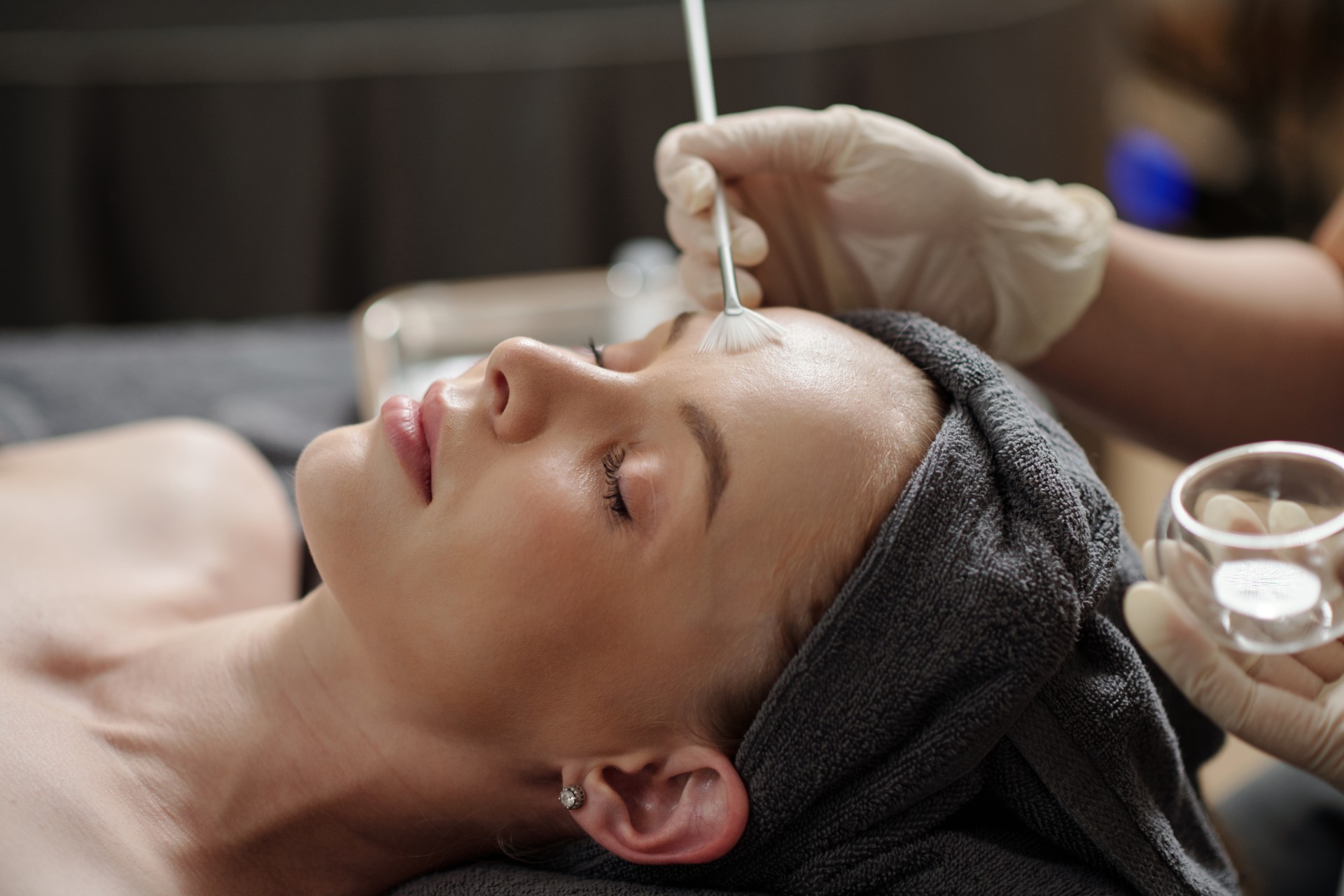 Esthetician applying a chemical peel during a facial treatment at The Spa at Dolphin Bay to improve skin texture, tone, and overall radiance.