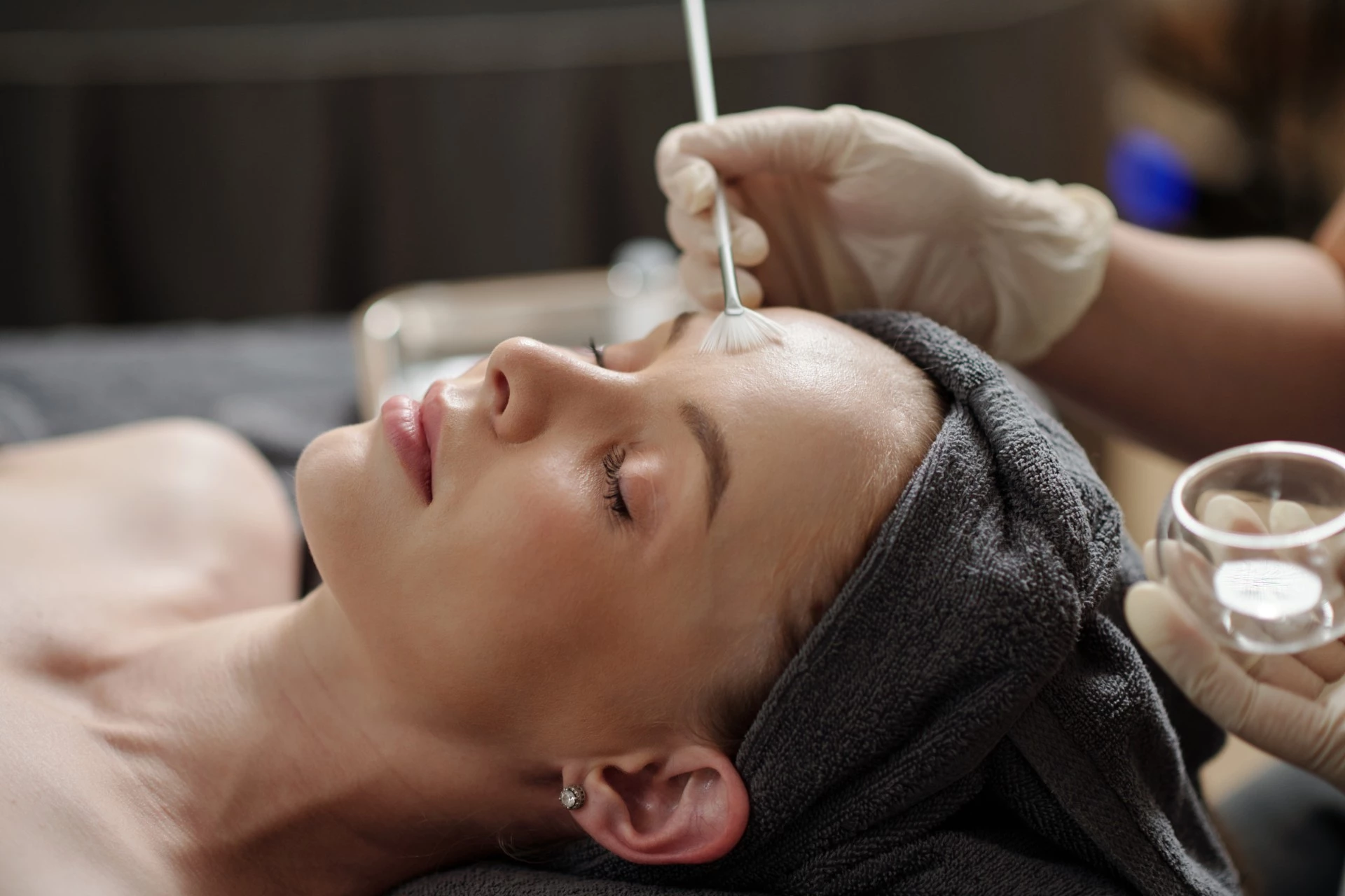 Esthetician applying a chemical peel during a facial treatment at The Spa at Dolphin Bay to improve skin texture, tone, and overall radiance.