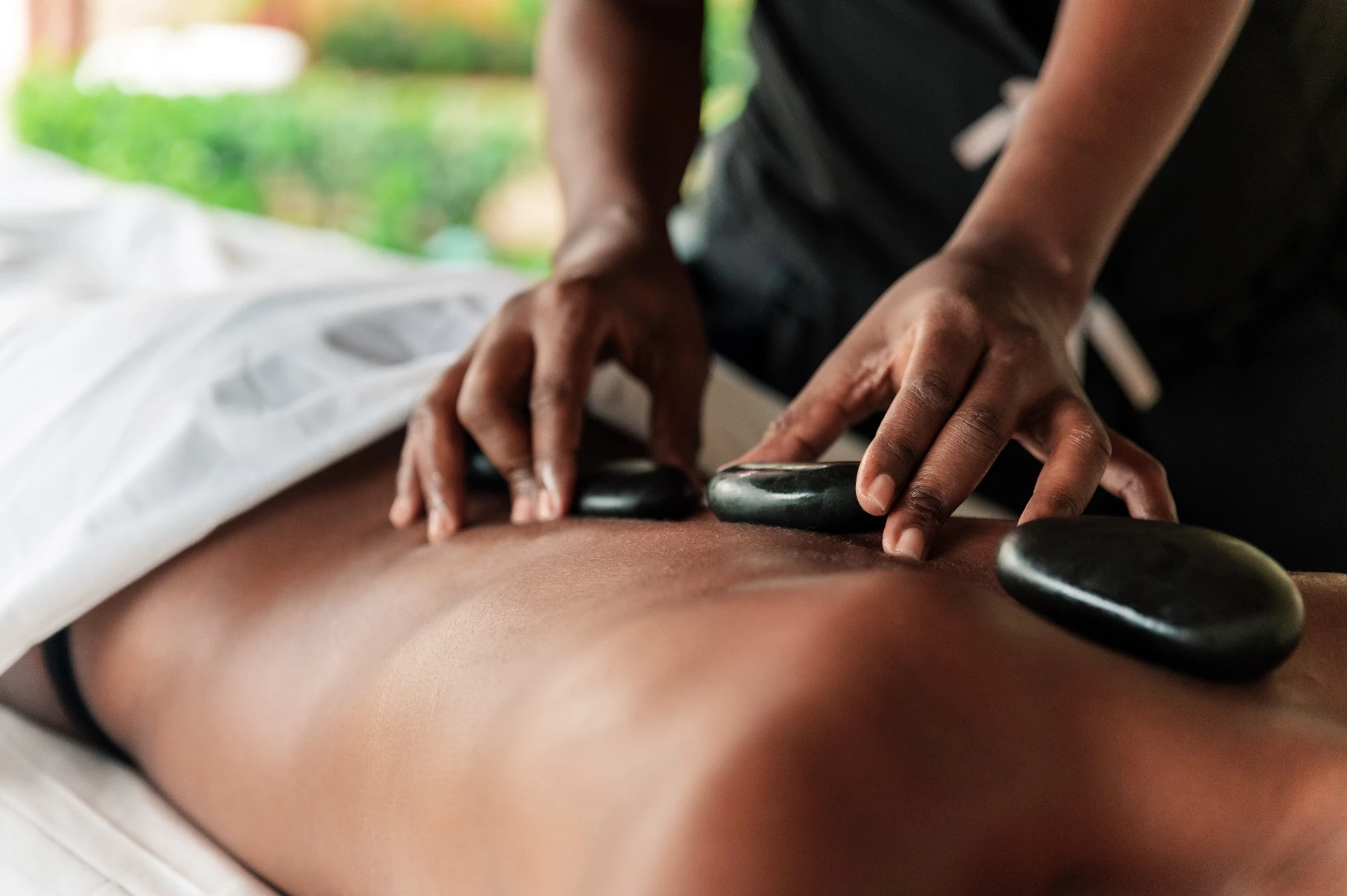 a person receiving a hot stone massage
