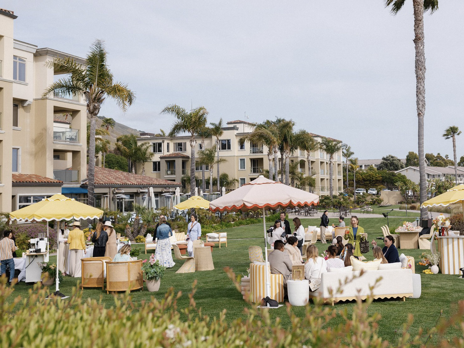 Elegant oceanfront lawn wedding celebration at Dolphin Bay Resort & Spa featuring Italian cuisine catered by Lido Restaurant & Lounge with tables, Italian chic décor, and coastal views.