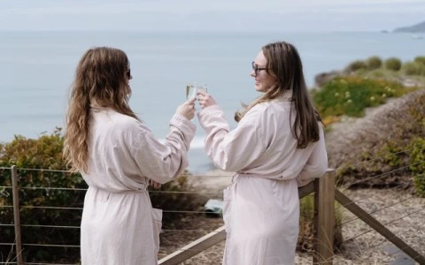 two women wearing white dresses