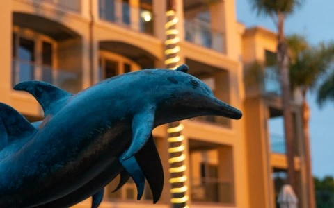 a statue of a dolphin in front of a building