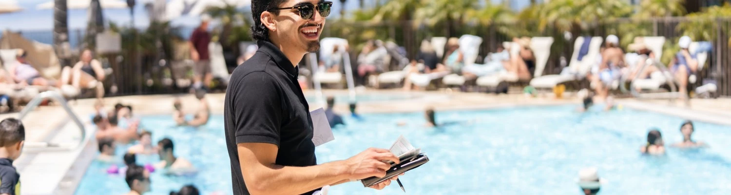 Man taking food orders at a pool
