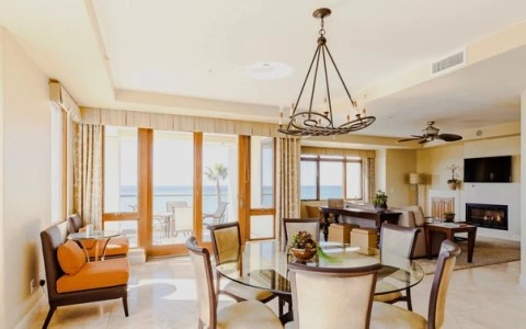 a living room with a chandelier and a dining table