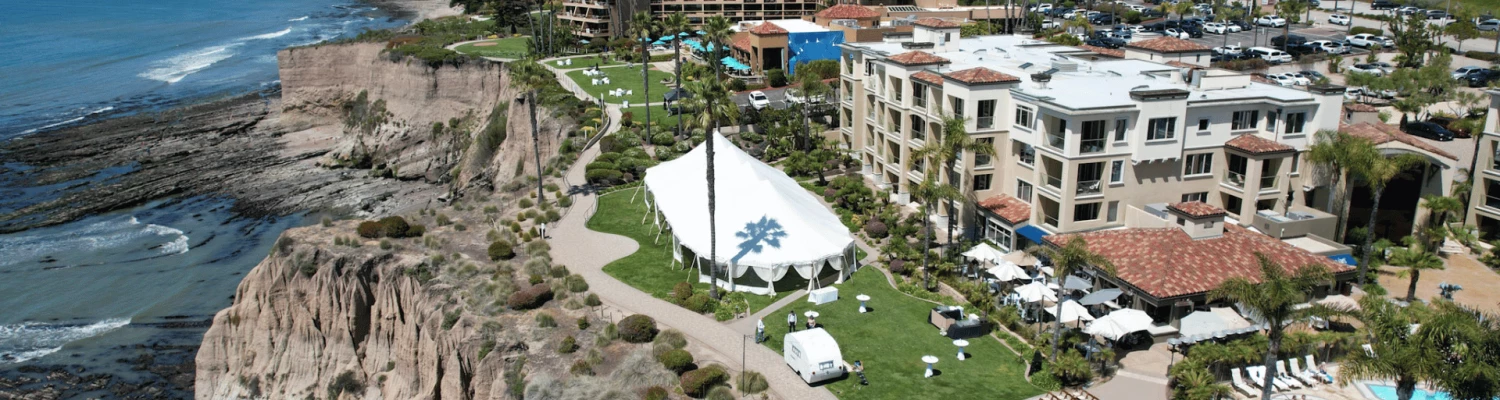 a aerial view of a resort with a beach and a large body of water