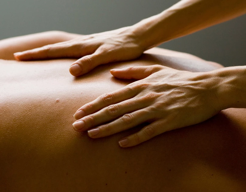 hands giving a relaxing back massage