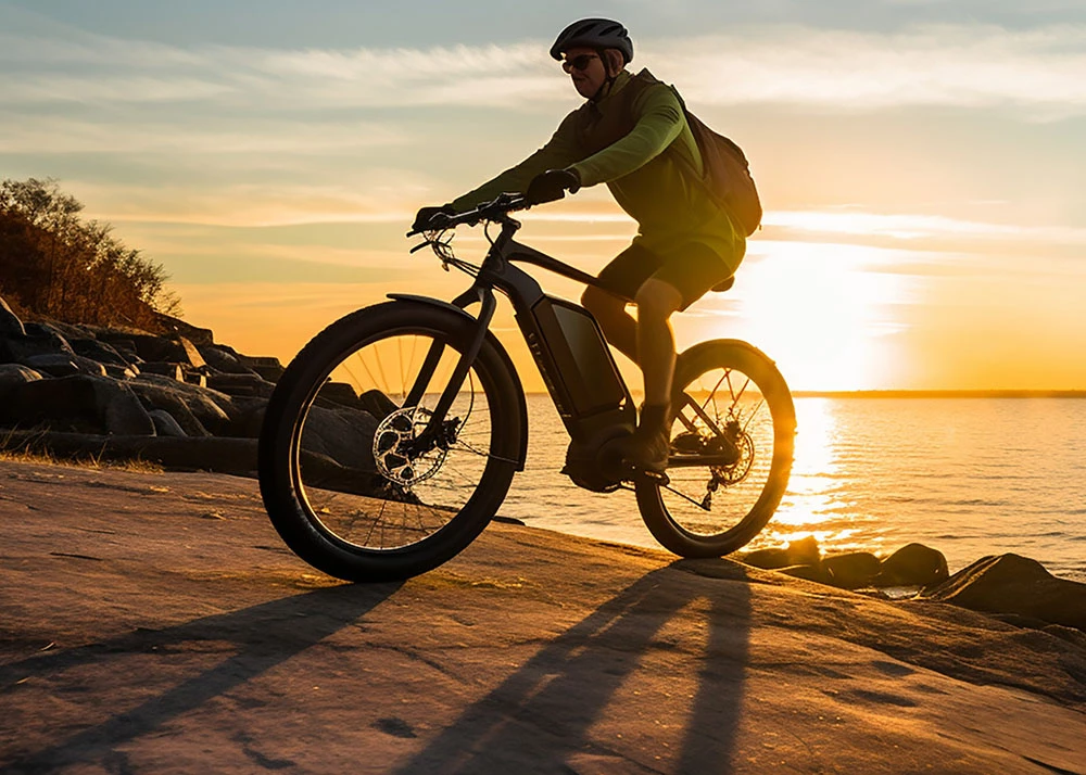 a man riding a bike on a beach