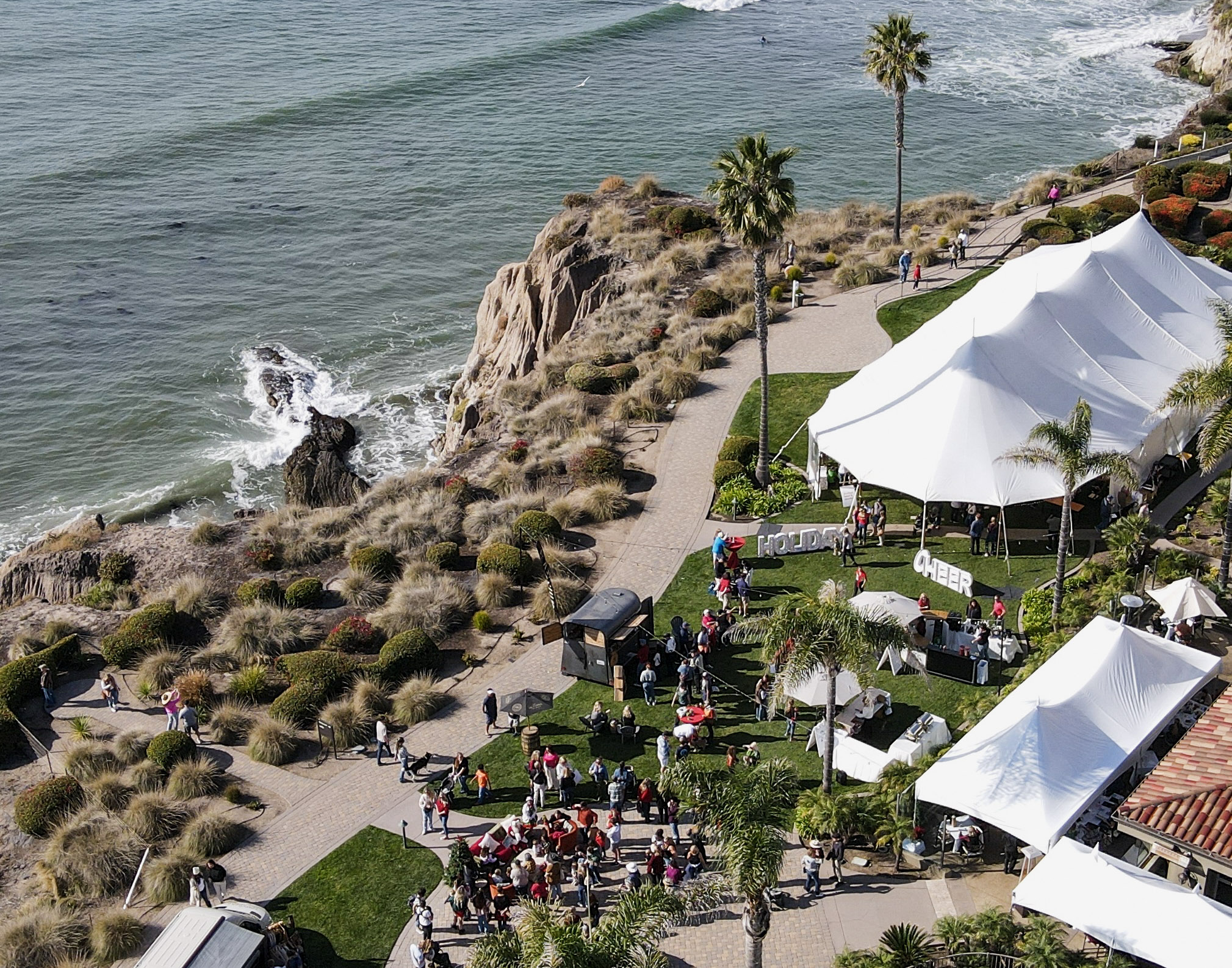 a group of people outside by the ocean