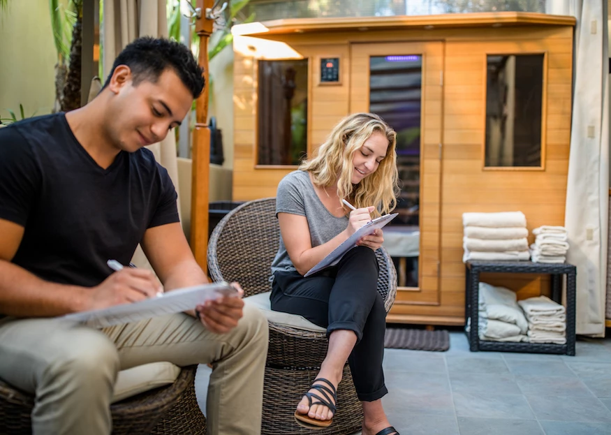 infrared sauna with people filling out forms