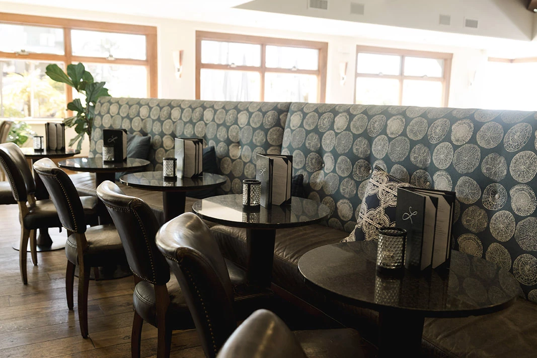 Inviting lounge seating with tables and chairs at the Bar & Lounge at Dolphin Bay Resort & Spa, Pismo Beach California