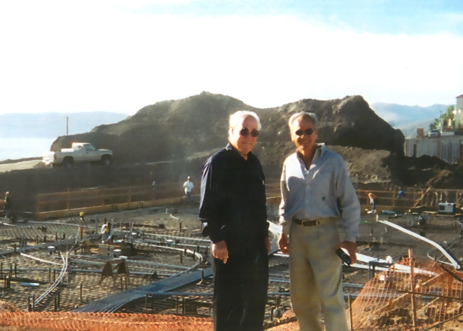 two men standing on a construction site
