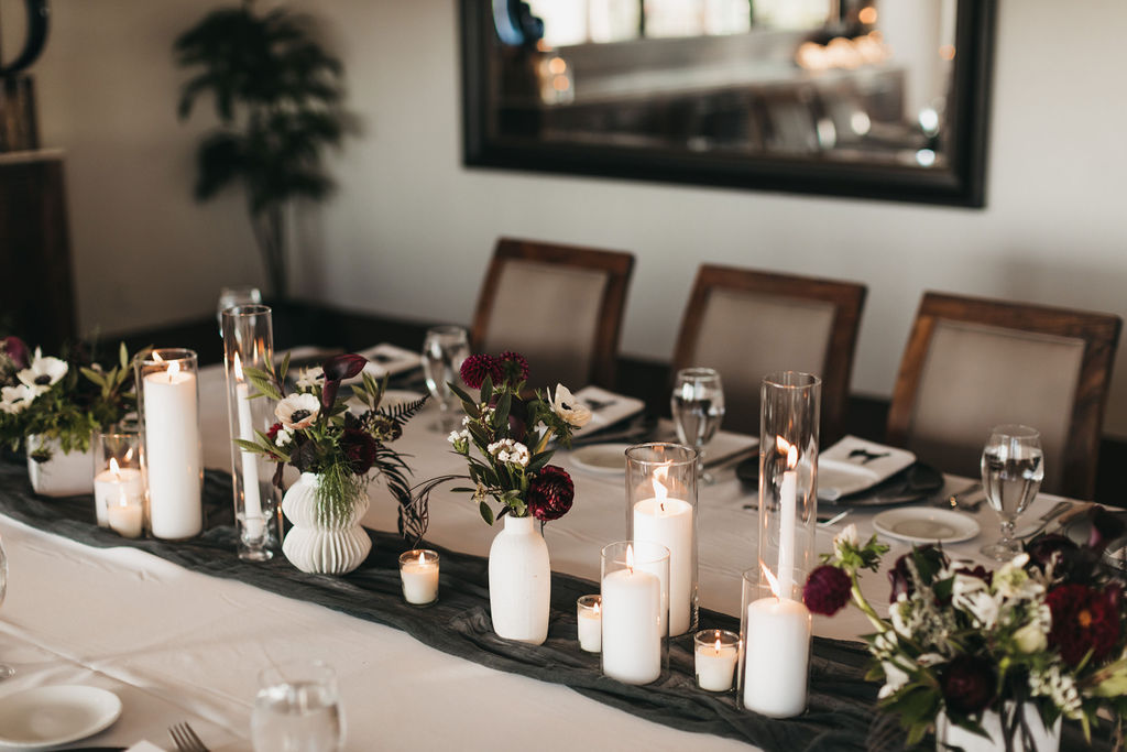Wedding reception table décor inside the Coastal Room at Dolphin Bay Resort & Spa in Pismo Beach — elegant place settings, candles, and soft coastal tones creating a warm, inviting atmosphere for intimate gatherings.