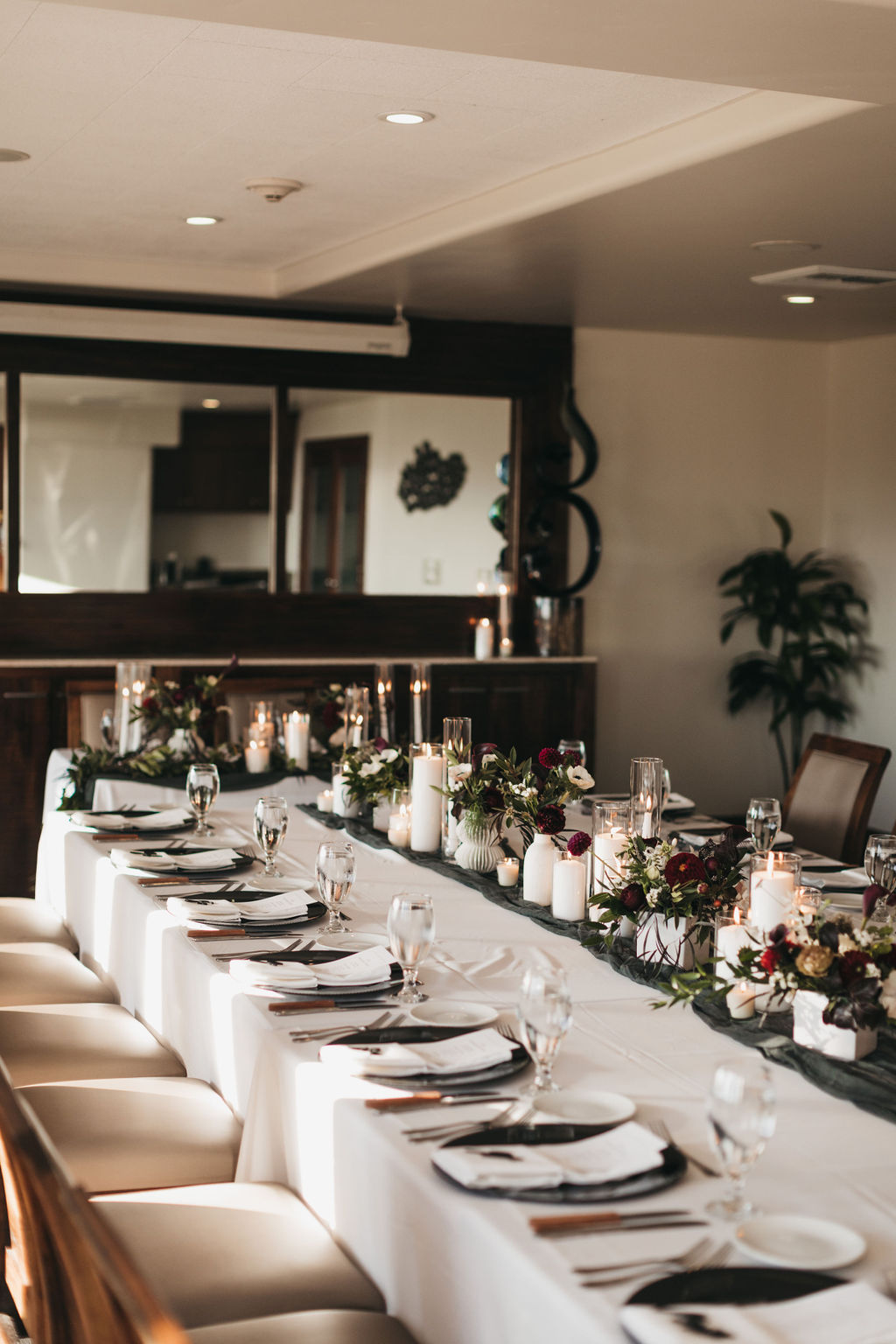 Coastal Room wedding reception at Dolphin Bay Resort & Spa in Pismo Beach — long dining table leading to a sweetheart table, indoor space with flexible layouts ideal for intimate weddings in any weather.