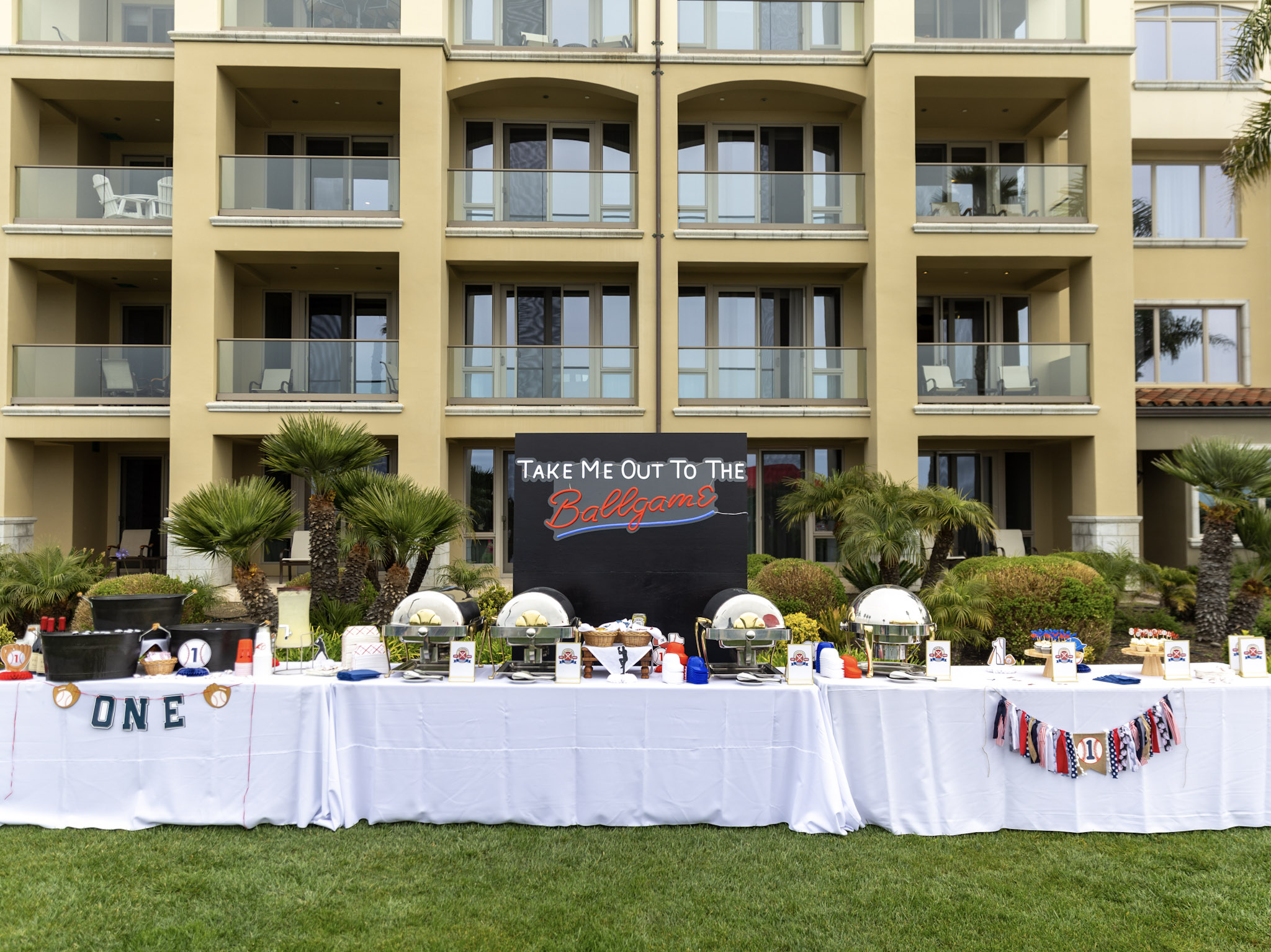 Baseball-themed kids’ birthday party on the oceanfront lawn at Dolphin Bay Resort & Spa with buffet setup, coastal views, and fun outdoor décor.