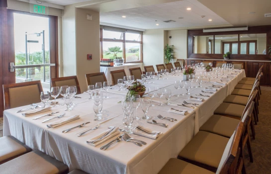 a long table with white tablecloths and glasses