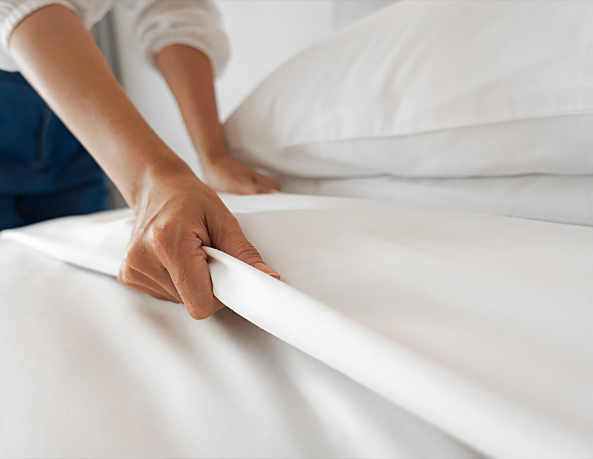 a person's hand on a white sheet