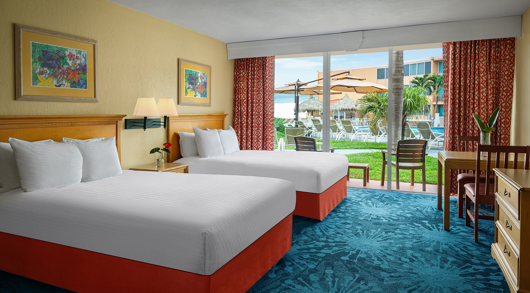 a hotel room with two beds and a sliding glass door