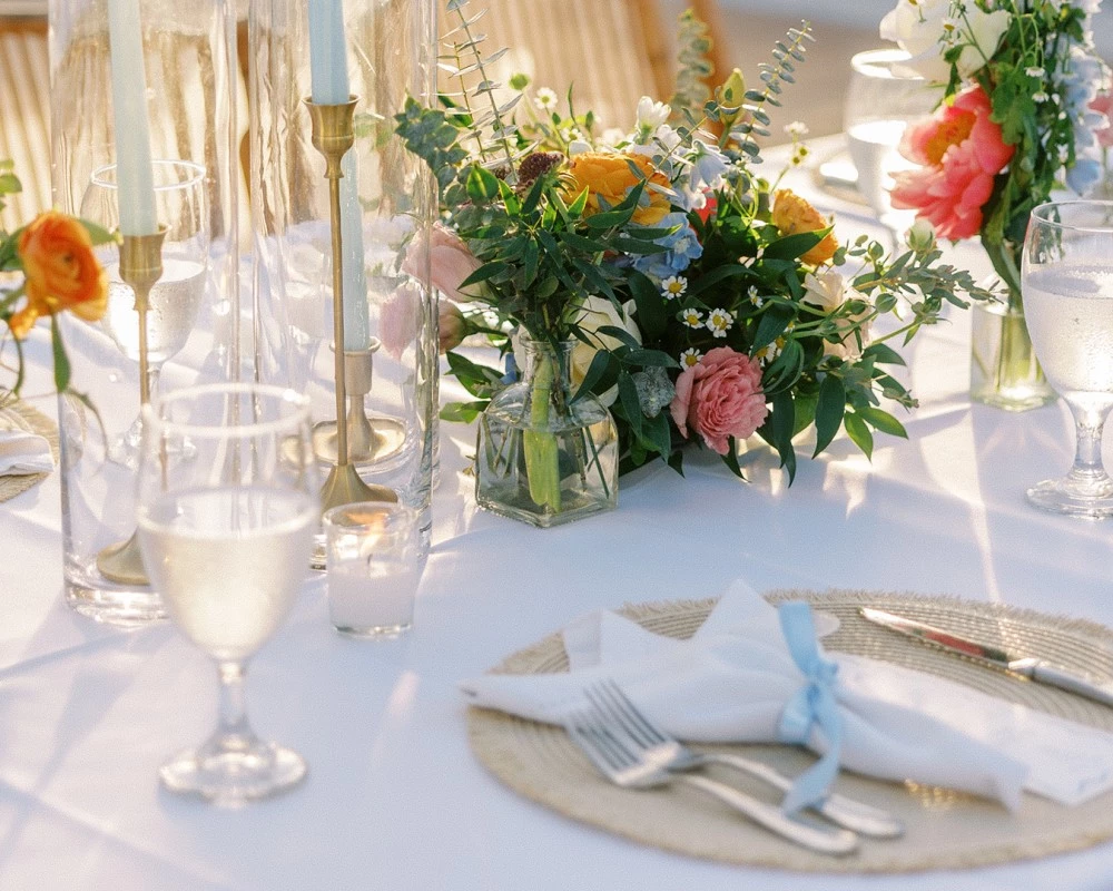 a table set with flowers and candles