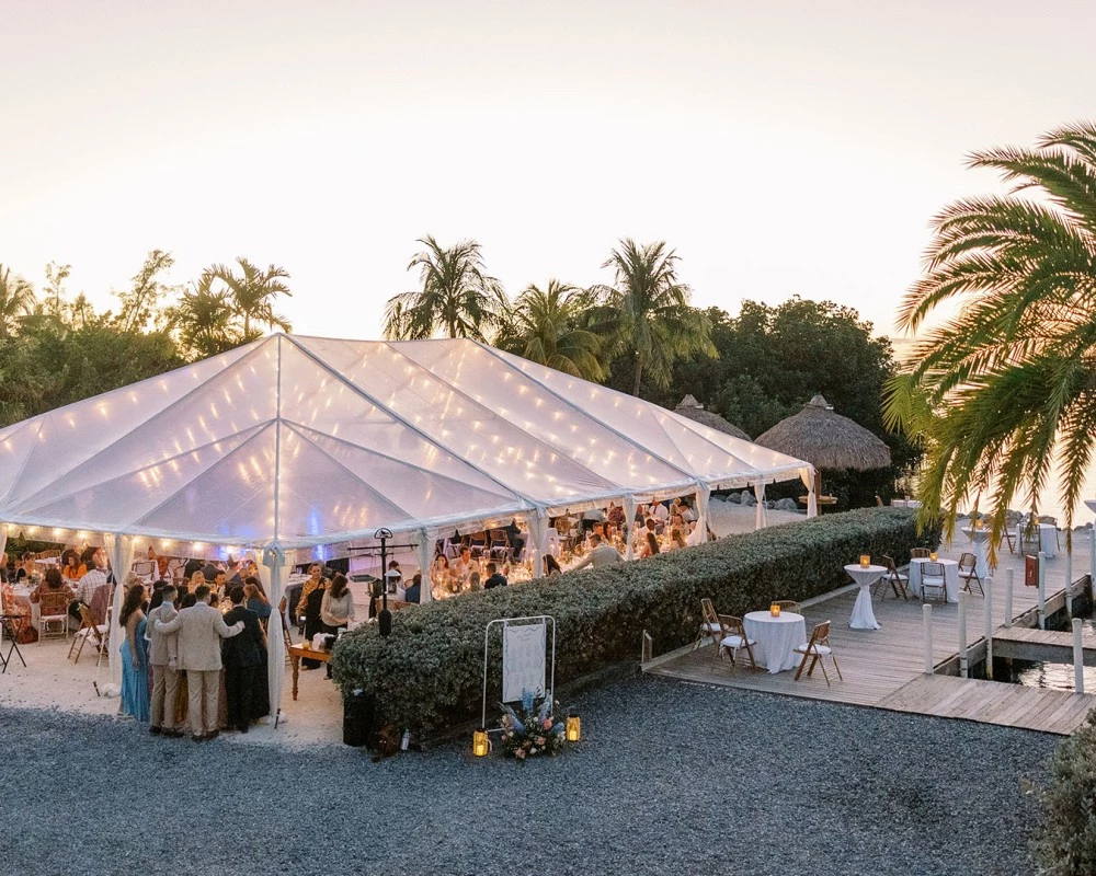 a large white tent with people standing around