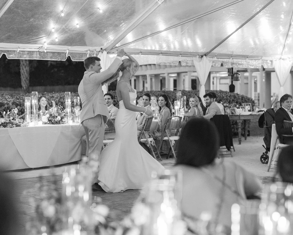 a man and woman dancing in a tent