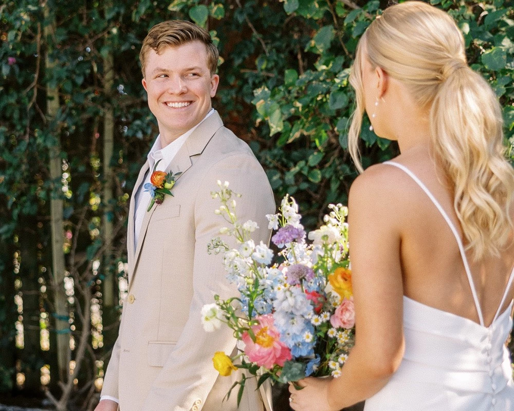 a man and woman holding flowers