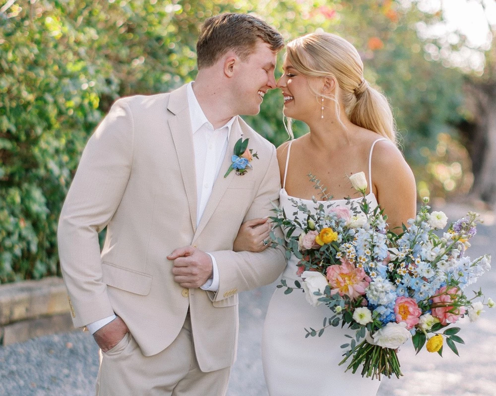 a man and woman in wedding attire holding flowers