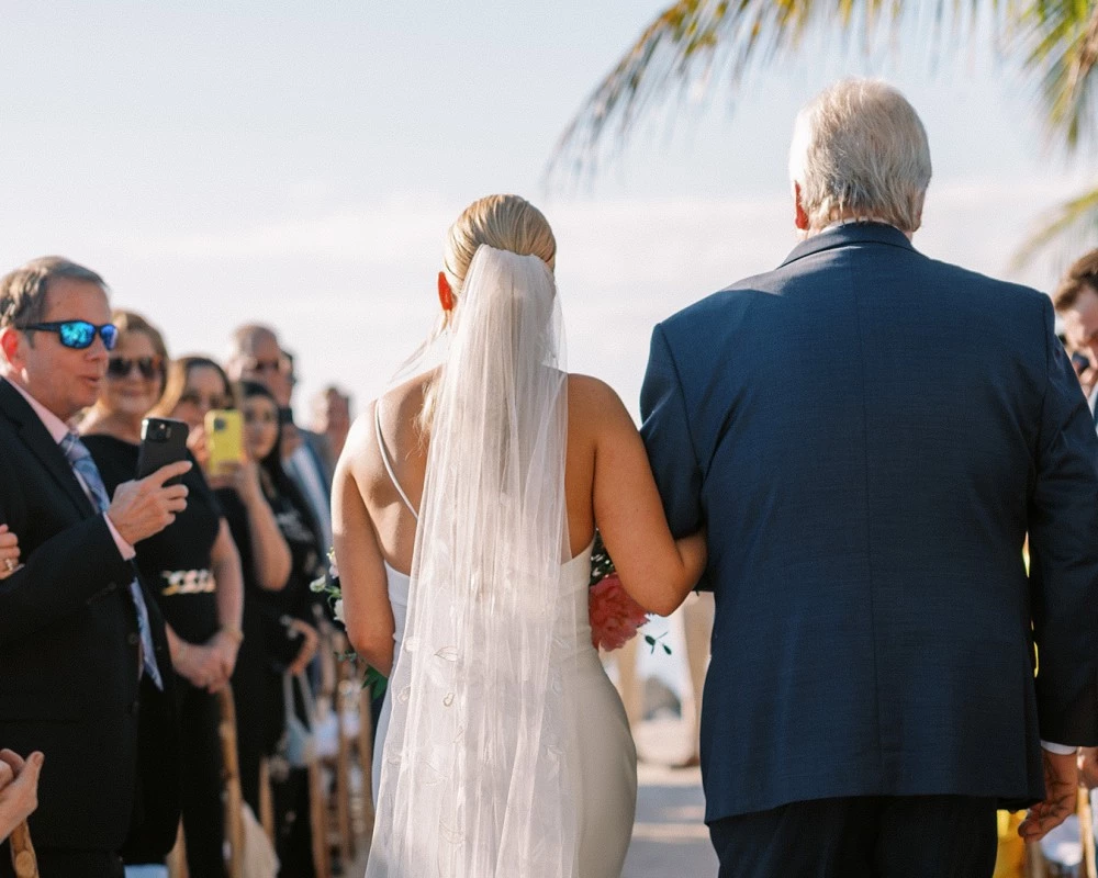 a man and woman walking down a beach