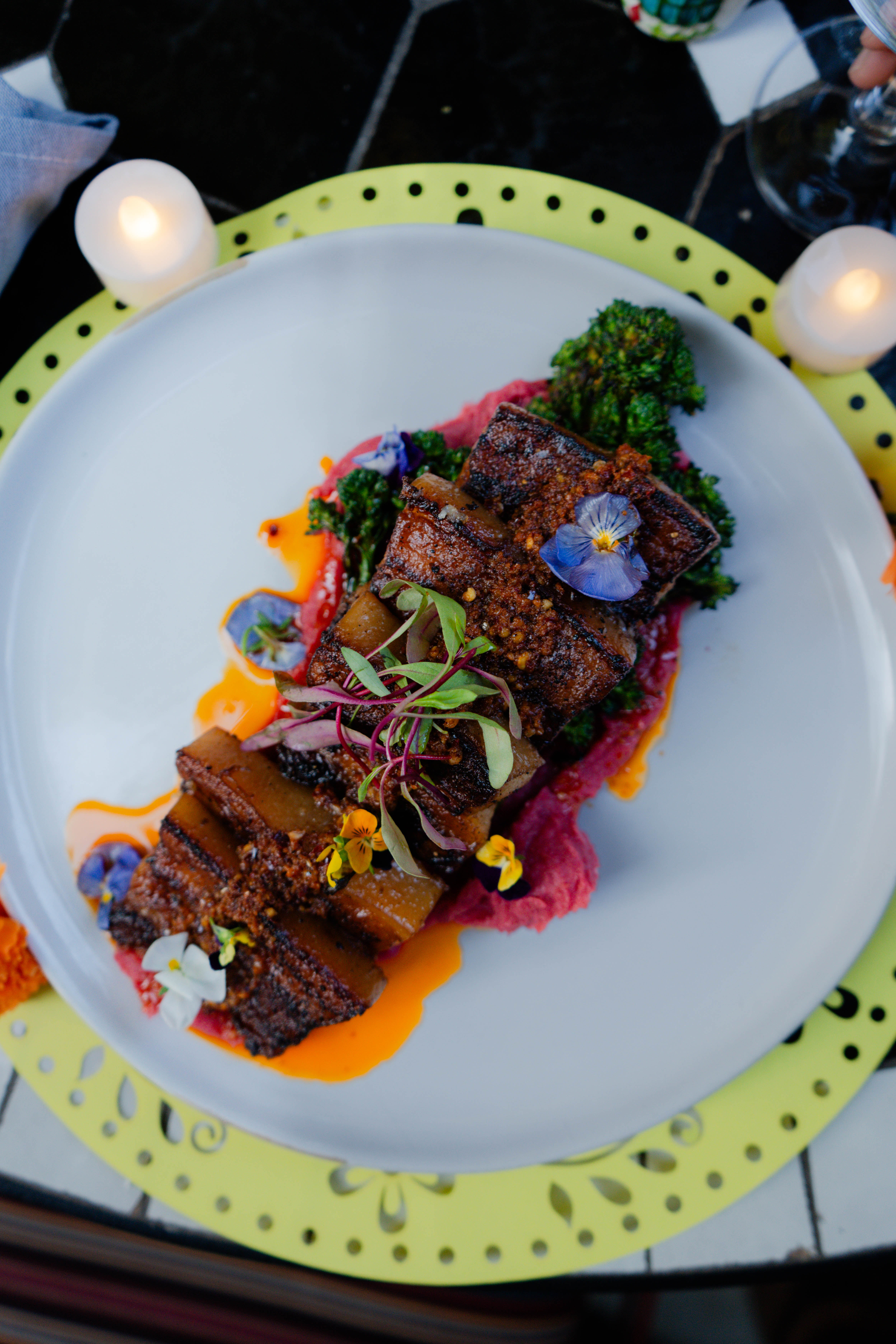 a plate of food with flowers and sauce