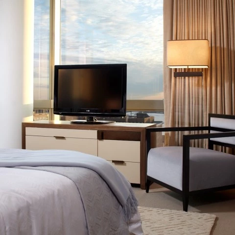 a bedroom with a tv and a chair