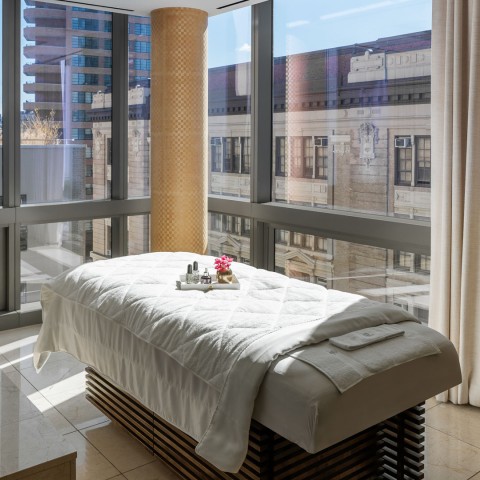 a massage table in a room with windows