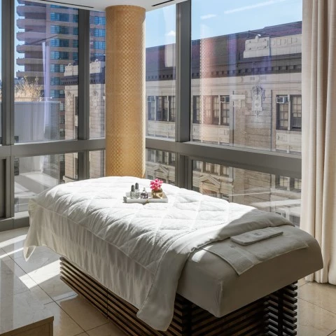 a massage table in a room with windows