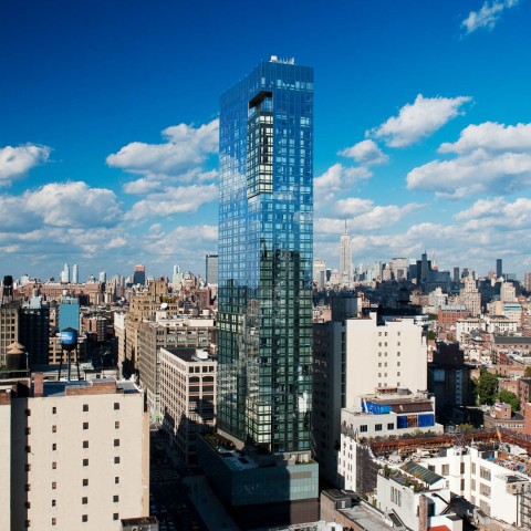 a tall glass building in a city