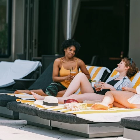 a group of women sitting on lounge chairs