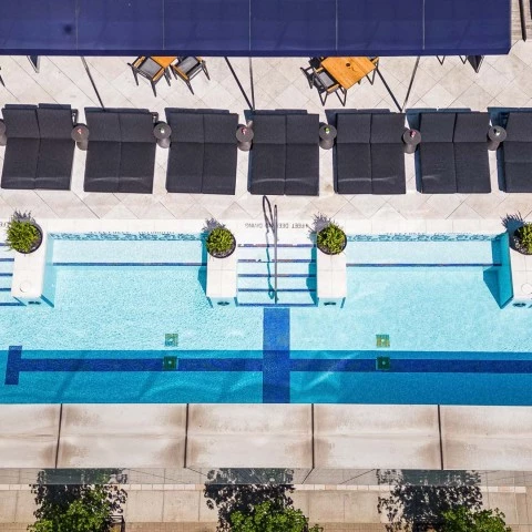 a pool with chairs and a table