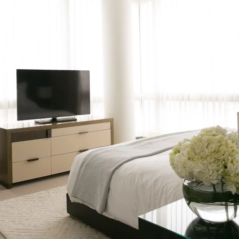 a bedroom with a tv and a bed